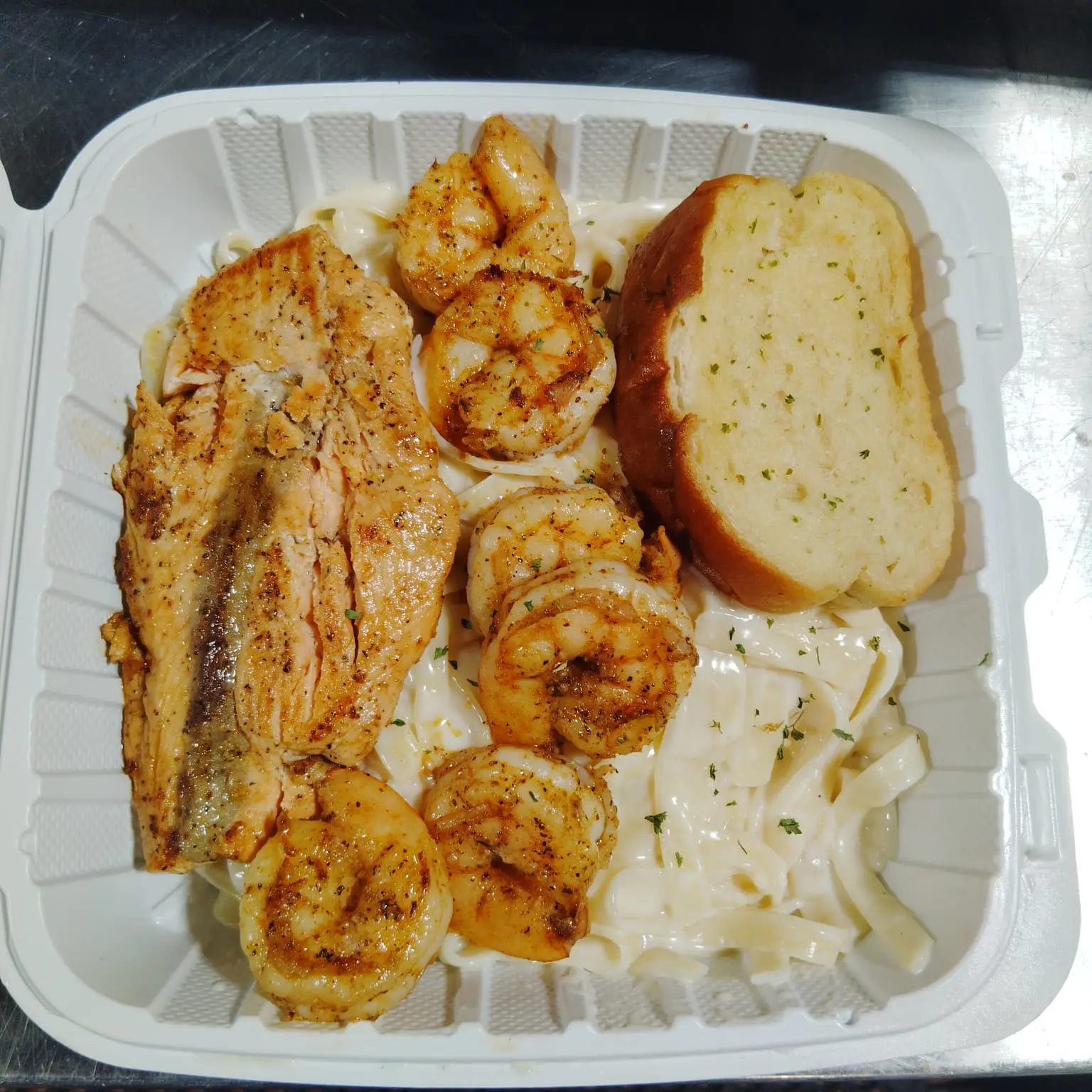Fish and shrimp alfredo takeout order ready for pickup at Dinner Is Served near North Shore Medical Center