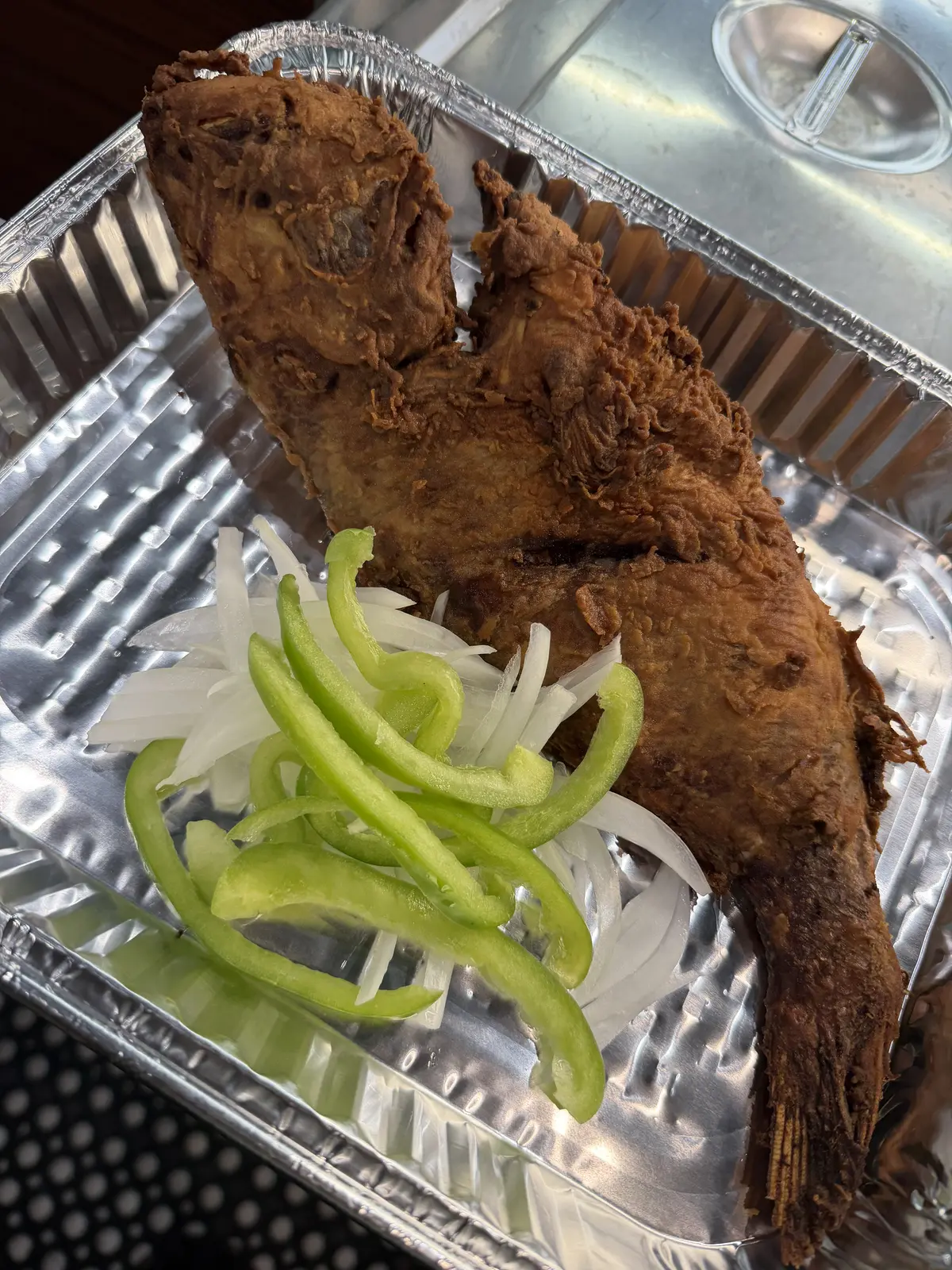 A whole fried snapper served fresh at Dinner Is Served, an ideal centerpiece for catered events near Miami Shores