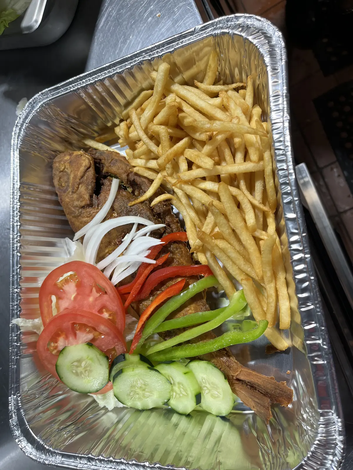 Whole fried snapper combo with fries and fresh vegetables at Dinner Is Served near the hospital